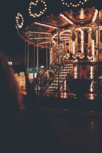 a merry go round is lit up at night