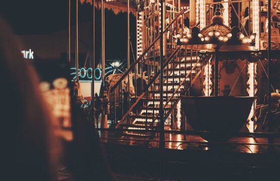 a merry go round is lit up at night