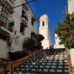 white concrete building near green trees during daytime