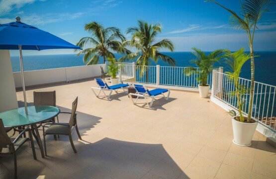 Blue Loungers on Beige Balcony Beside Sea Landscape Photography