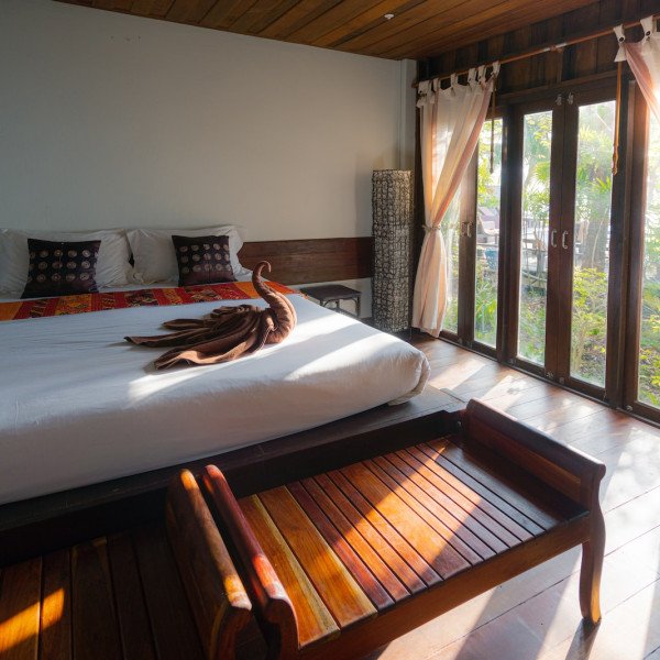 white bed linen with brown wooden bed frame